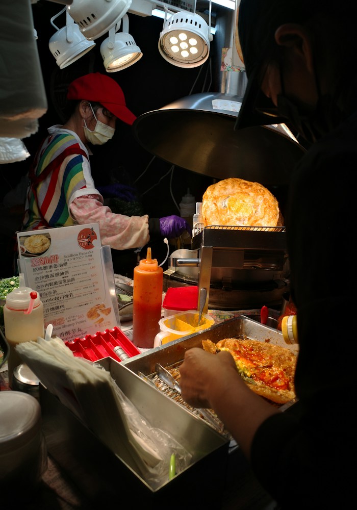 Street food vendor preparing food at a Taipei night market, Taiwan