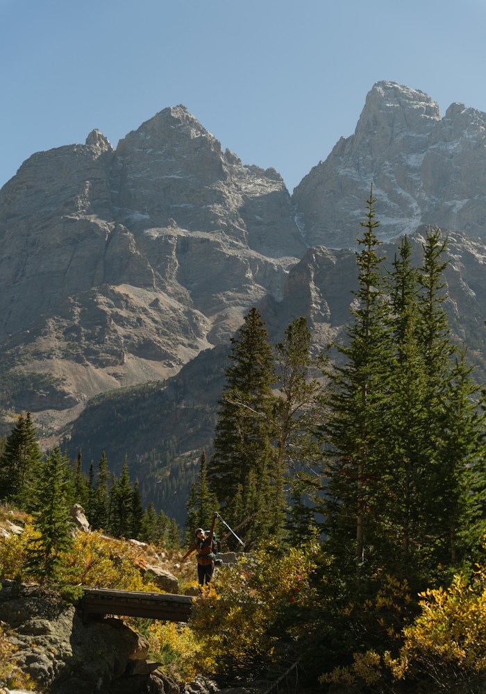 Lone hiker beneath the peaks in Grand Teton National Park, Wyoming, USA