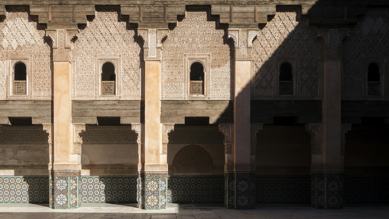 Ornate warm-toned architecture at Ben Youssef Madrasa in Marrakech